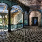 Abandoned interior with arches and a view through a window